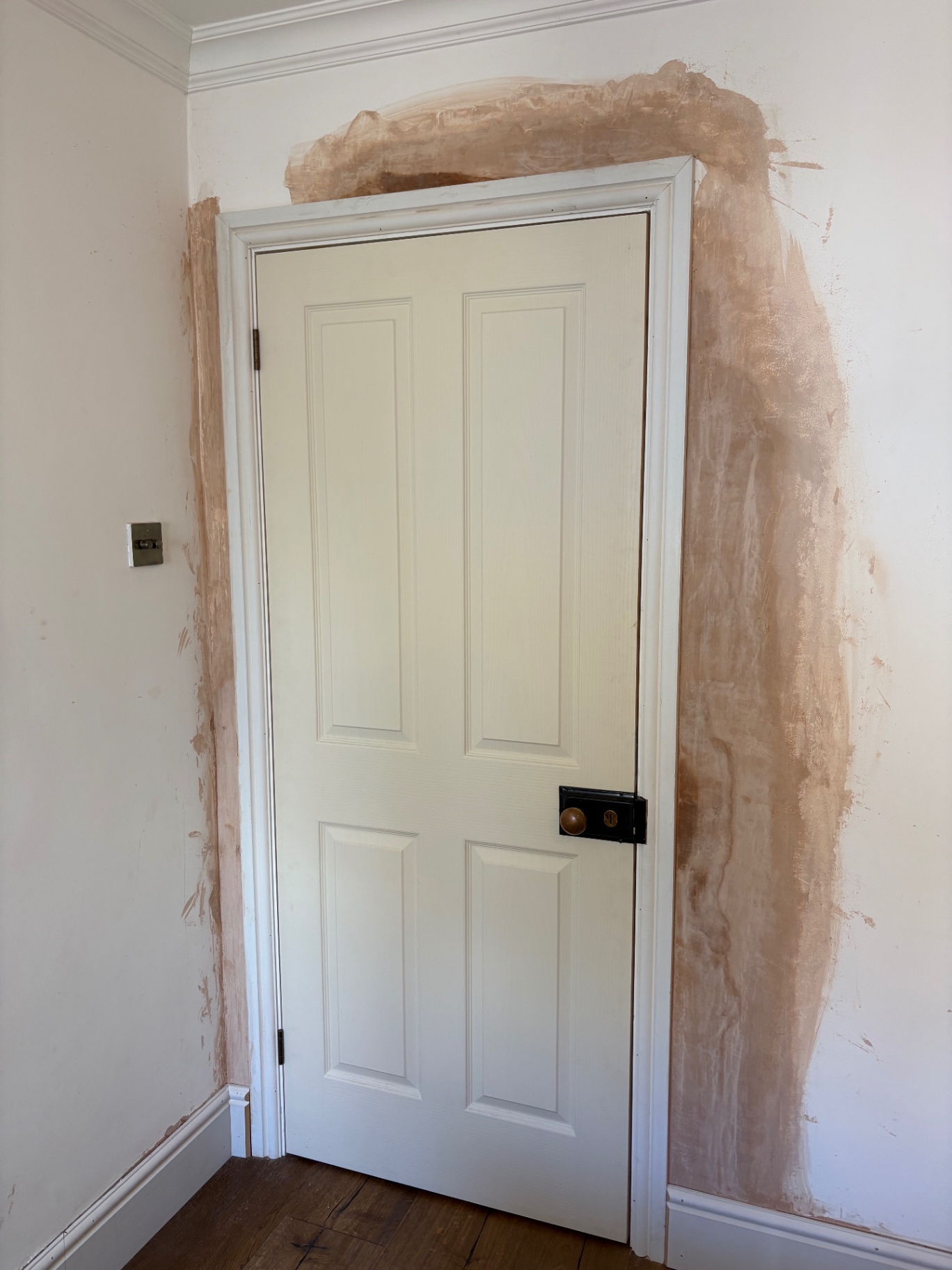 Six-panel internal door ready during plastering and prep work