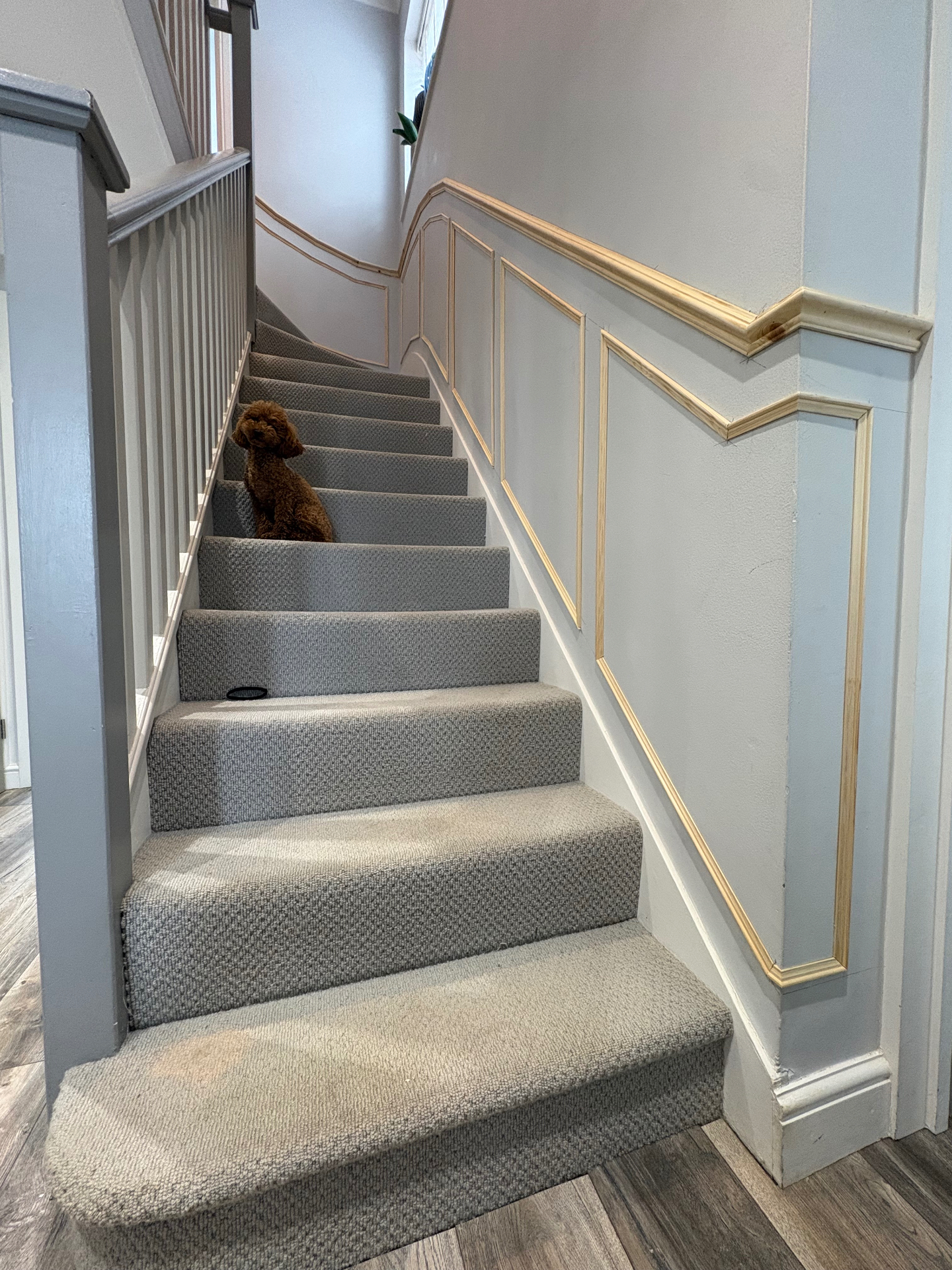 Full staircase panelling installation with detailed mouldings and handrail trim