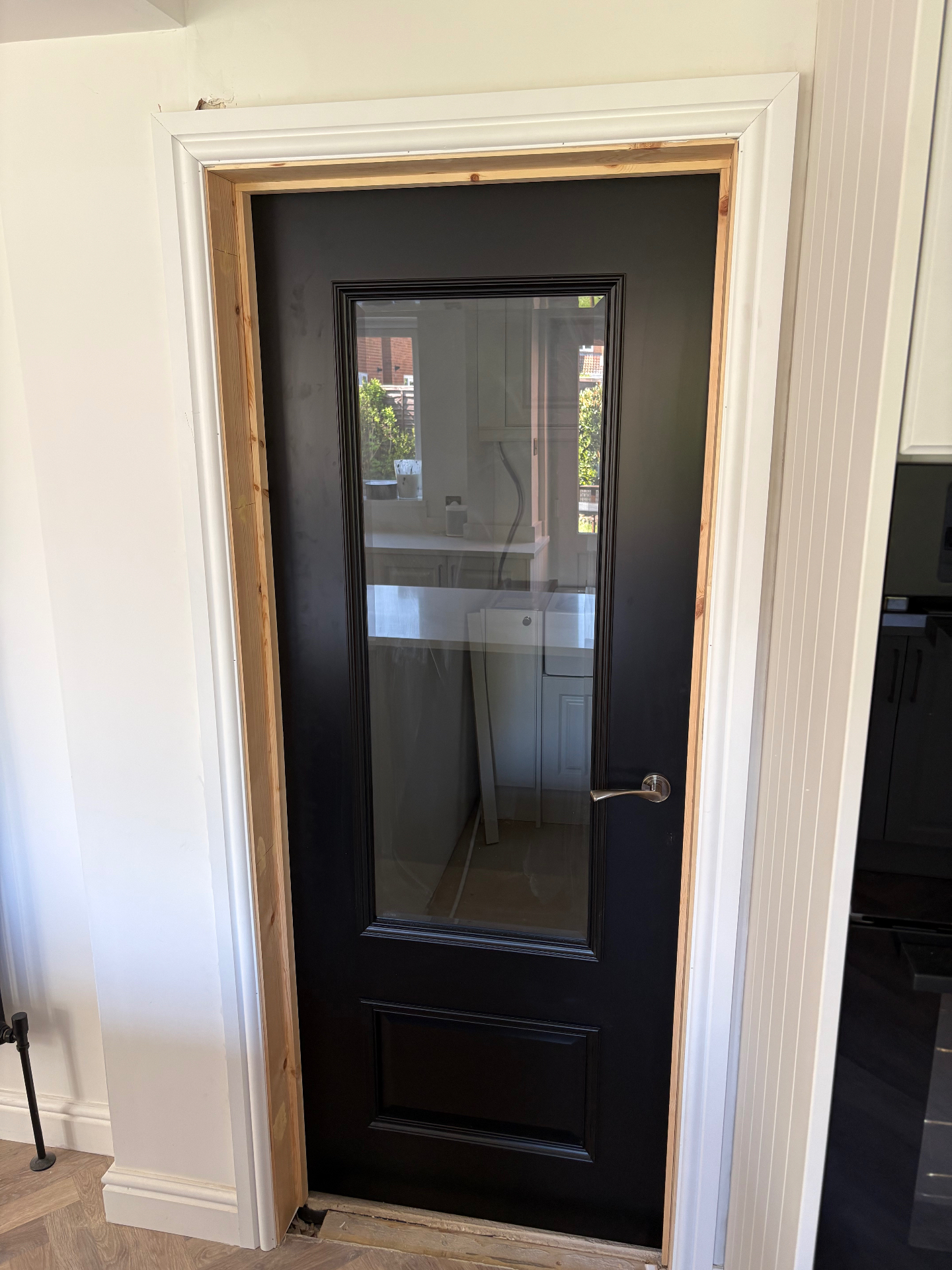 Black glazed internal door newly fitted with pine lining