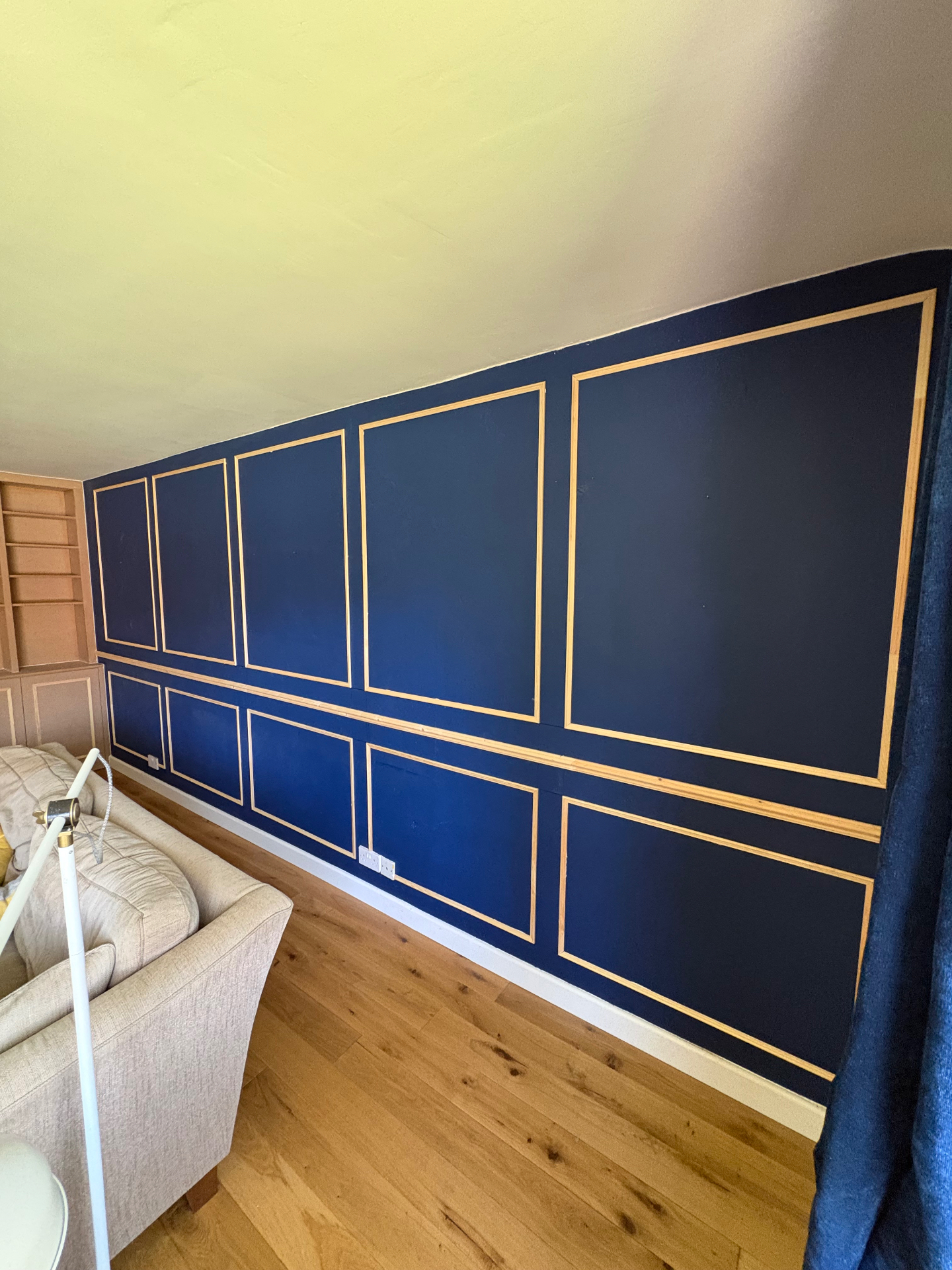 Bold navy feature wall with traditional panel mouldings and natural timber beading