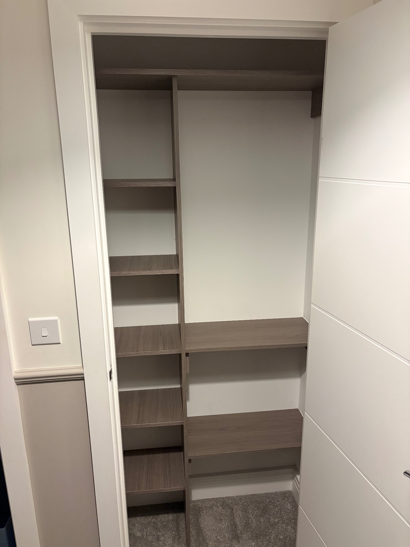 Bespoke alcove wardrobe interior with shelving tower, hanging rail and drawer space