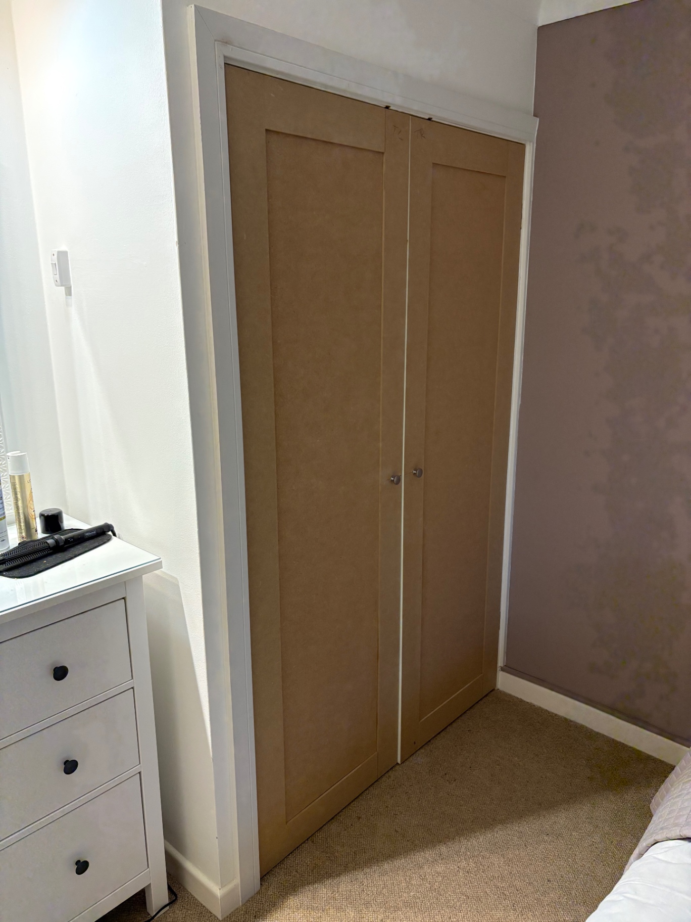 Bespoke fitted bedroom wardrobe with shaker doors in raw MDF ready for paint