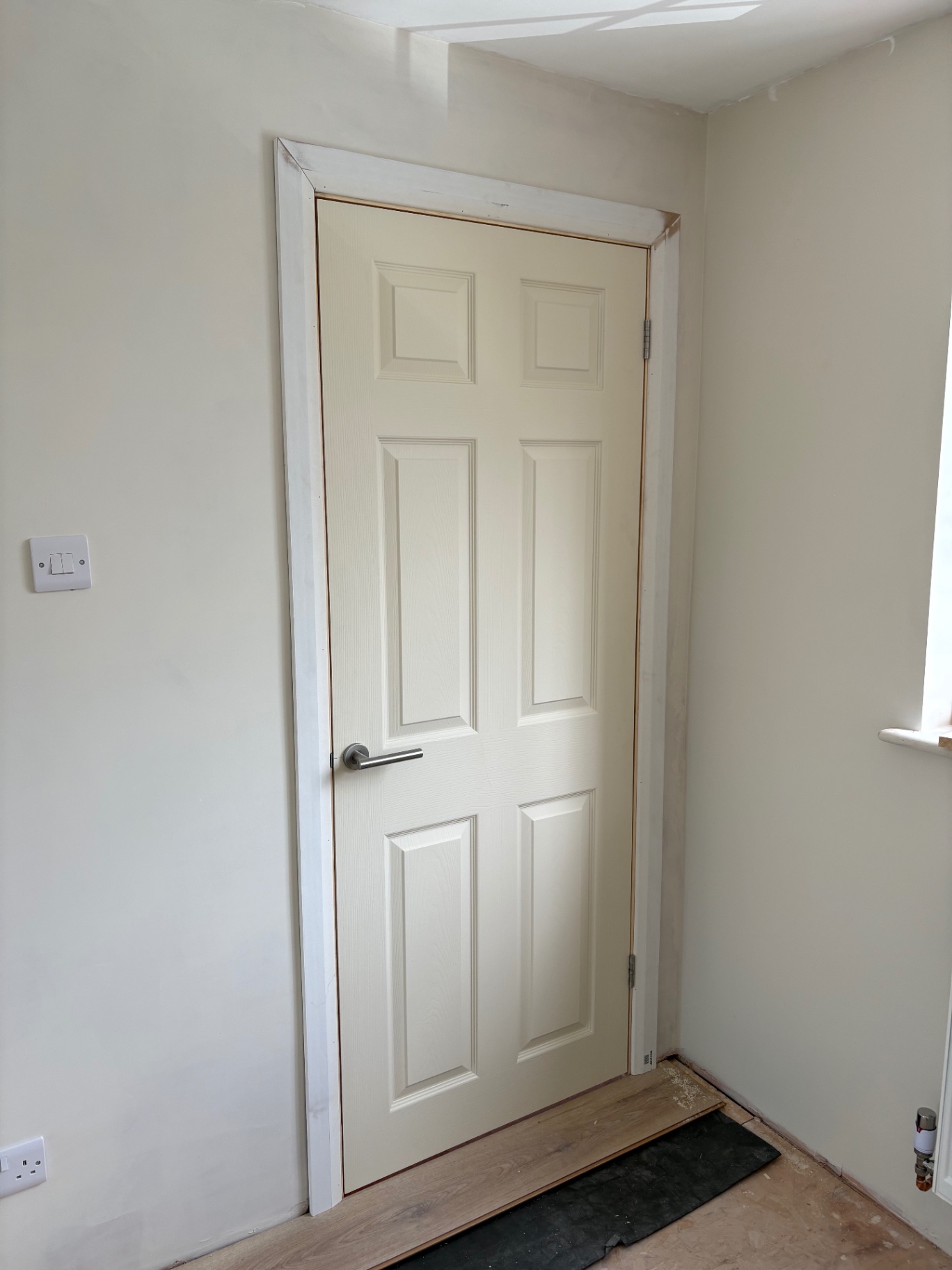 New six-panel internal door fitted in a refurbished opening