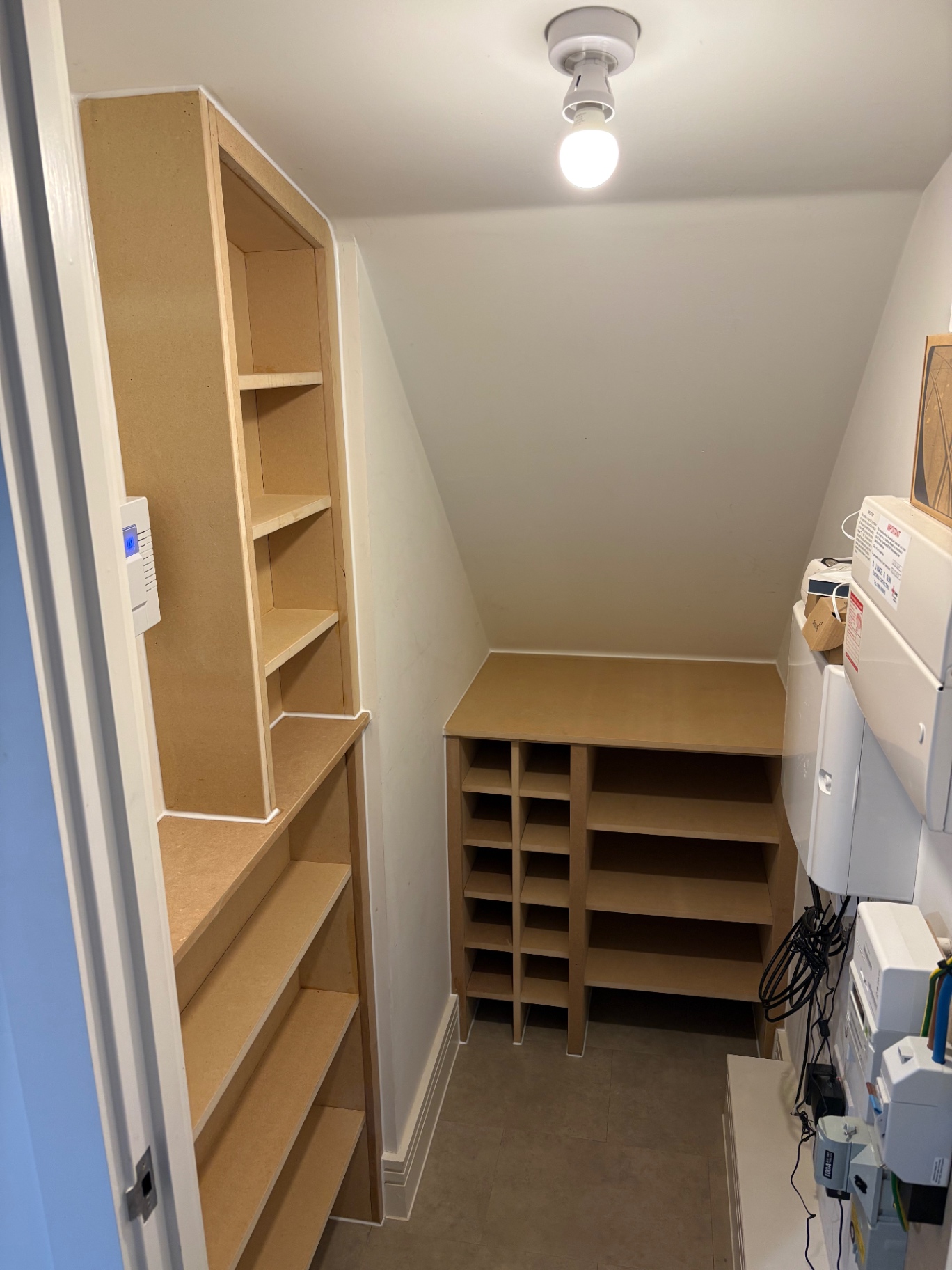 Bespoke utility cupboard shelving and pigeonhole shoe storage in raw MDF