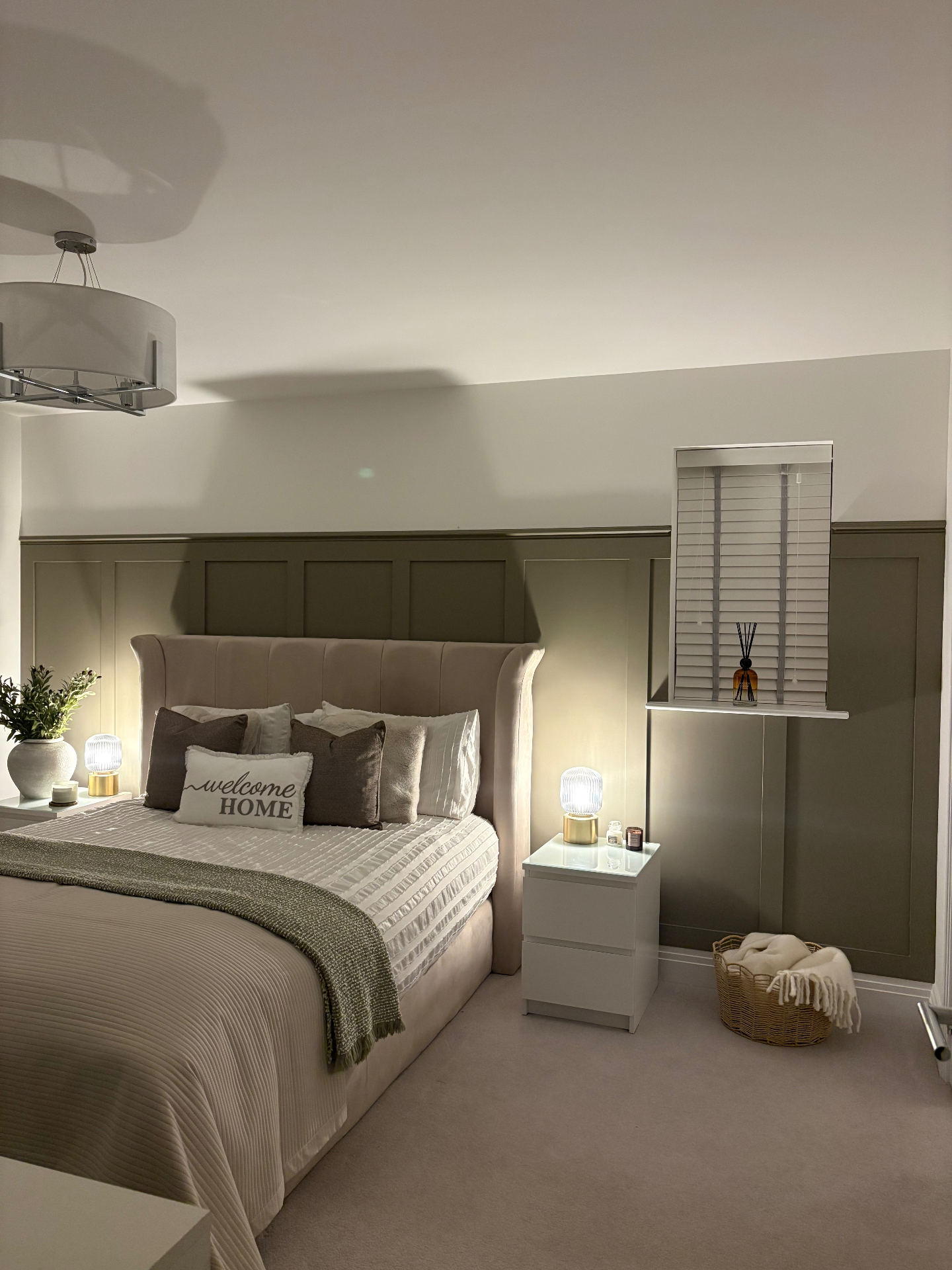 Olive half-height bedroom panelling finished behind a upholstered bed
