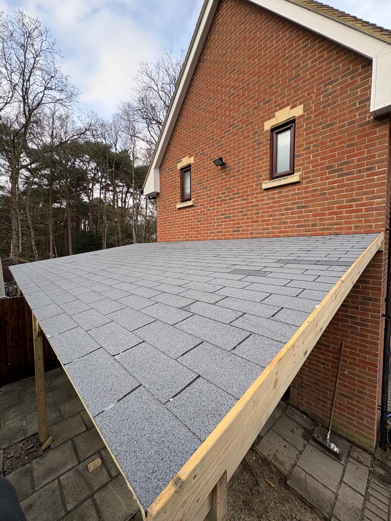 Close-up of new felt-shingle roof on a bespoke timber garden canopy