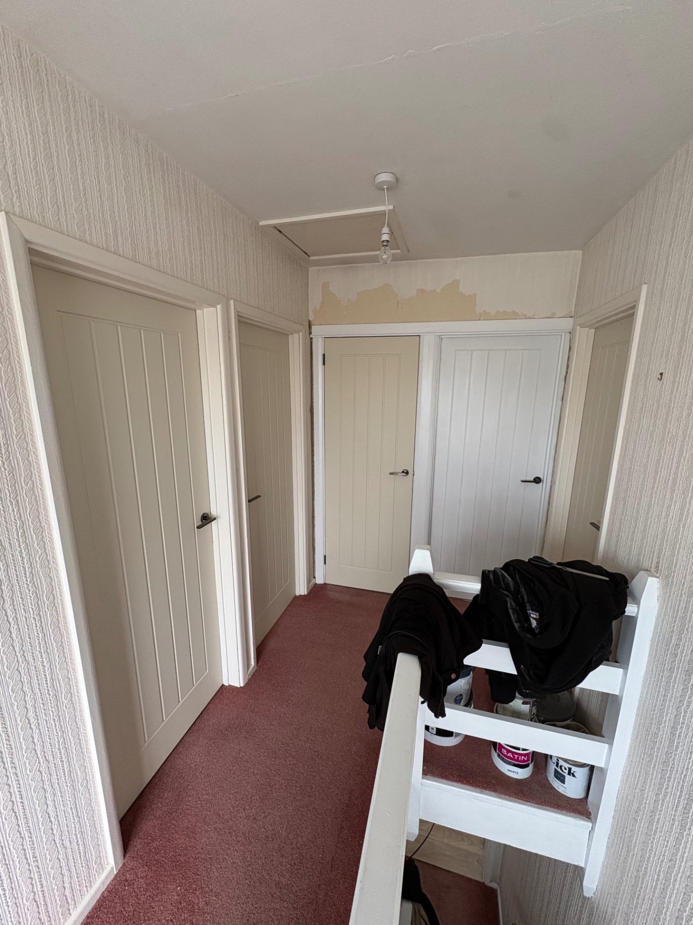 Set of matching internal shaker doors fitted along an upstairs landing