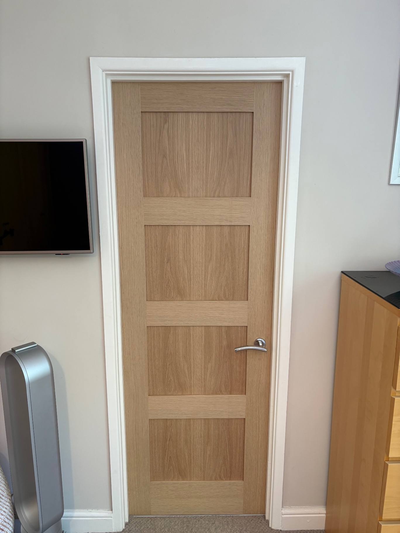 Light oak four-panel internal door with chrome lever handle