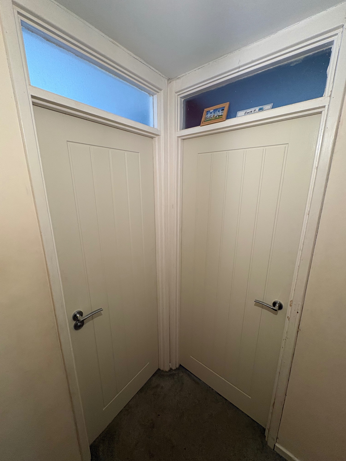 Pair of white internal doors with glazed top panels and chrome handles